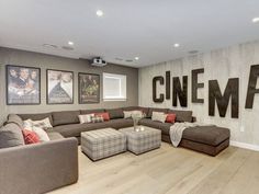 a living room filled with furniture and pictures on the wall