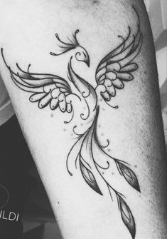 a black and white photo of a bird tattoo