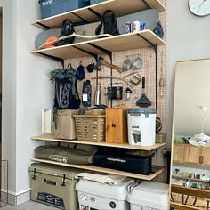 there are many different items on the shelves in this room, including coolers and bags