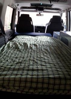 an empty bed in the back of a van