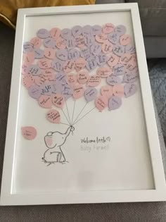 a white frame with pink and purple hearts attached to it, in the shape of a dog holding a balloon