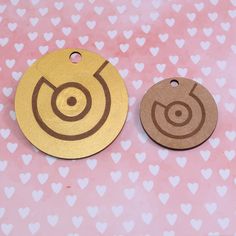 two wooden tags with hearts in the background