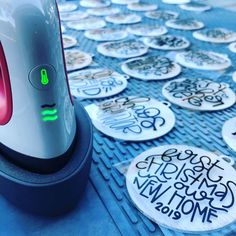 a computer mouse sitting on top of a table covered in stickers and magnets