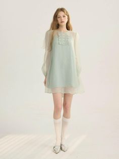 This product is a graceful sheer mini dress, designed to impart an air of ethereal beauty. It features delicate details that imbue it with a soft, romantic character, perfect for creating a subtle yet enchanting presence. With its translucent overlay and intricate bodice, this piece evokes a dreamy, almost fairytale-like quality. - This sheer mini dress captivates with its gossamer sleeves and floaty silhouette, offering an aura of delicate charm- The bodice is adorned with ornate embellishments that add a touch of elegance and fine craftsmanship- Its lightweight fabric ensures a comfortable and breezy wear, ideal for special occasions or as a standout daywear piece- A handmade Cali medal decoration is thoughtfully placed to enhance the dress with an exclusive accent Light Green Dress, Sheer Mini Dress, Lit Outfits, Future Clothes, Couture Details, Overlay Dress, Romantic Dress, Ethereal Beauty, Sheer Dress