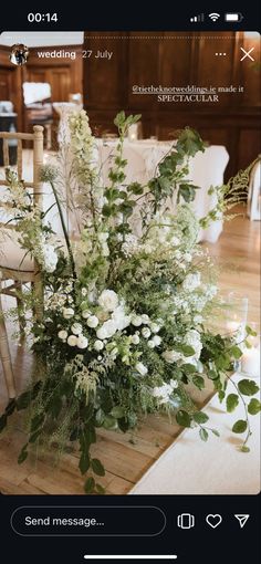 a bouquet of flowers sitting on top of a wooden table next to a white chair