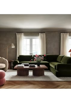 a living room with two couches and a coffee table in front of the window