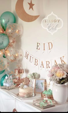 a table topped with balloons and cake next to a white mantle covered in confetti