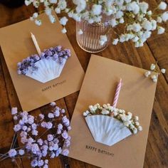 three greeting cards with flowers and candles on them, one is for a happy birthday