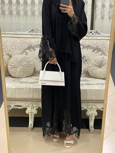 Discover elegance with our stunning black nidha abaya, intricately designed with delicate netted flowers. This piece combines timeless sophistication with a touch of contemporary charm, perfect for enhancing any wardrobe. Crafted from luxurious, breathable nidha fabric, it ensures both comfort and style. Ideal for special occasions or everyday wear, this abaya is a must-have for those who appreciate modest fashion with a floral flourish. Dubai Abaya Aesthetic, Abaya Flower Design, Net Abaya Designs, Arabic Abaya Designs Black, Abaya Fashion Black Muslim, Fancy Hijabi Outfits, Modern Abaya Black, Abaya Branding, Abaya Fashion Dubai Black