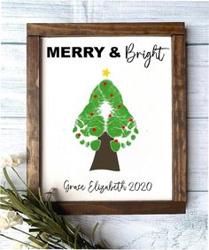 a framed christmas tree with the words merry and bright on it, surrounded by flowers