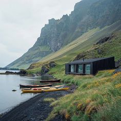 two canoes sitting on the shore of a body of water