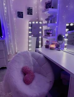 a white chair sitting in front of a mirror on top of a desk next to a dresser