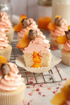 cupcakes with pink frosting and fruit toppings