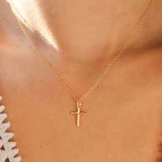 C R O S S ∙ N E C K L A C E This gold-filled piece is a meaningful and high-quality necklace that makes a perfect gift. It is comfortable, lightweight, and waterproof, making it perfect for everyday wear. This necklace is 16" with a 2" extension chain. M A T E R I A L S * Gold-filled materials - Our gold-filled jewelry has a minimum of 5% 14k gold by weight on top of a brass core. This layer of gold is thick enough to stand up to most wear and tear, creating an affordable yet long-lasting piece that is the closest to real gold jewelry. So, you can shower and sweat and don't have to worry about taking your jewelry off! F E A T U R E S * Dainty chain & charm - lightweight and perfect for everyday wear and layering with other jewelry * Soldered jump rings & thick charm jump ring - prevents th Rings Thick, Cross Necklace Gold, Dainty Cross Necklace, Hypoallergenic Necklace, Cross Gold, Christian Necklace, Real Gold Jewelry, Gold Filled Necklace, Gold Cross Necklace