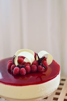 a dessert with raspberries and cream on top