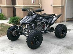 a black and silver four wheeler parked in front of a building