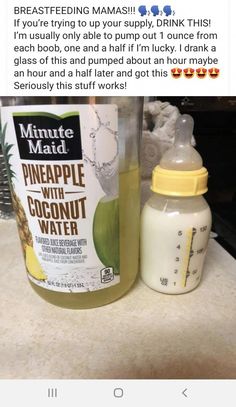 a bottle of pineapple with coconut water next to a baby bottle on a counter