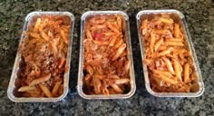 three pans filled with pasta and meat sitting on a counter top next to each other