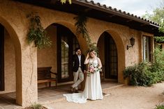 a bride and groom walking out of their home