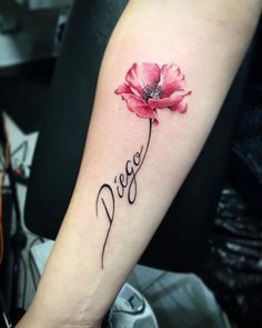 a red flower with the word peace written in cursive writing on the arm