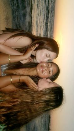 three young women are posing for the camera with their hair blowing in the wind and smiling