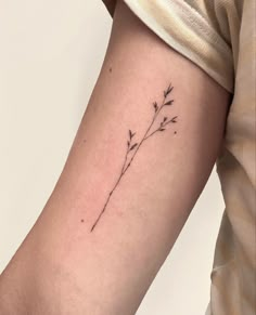 a small flower tattoo on the arm