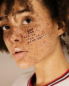 a man with freckles on his face has words written on his face