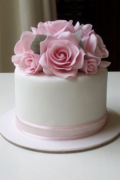 a white cake with pink flowers on top