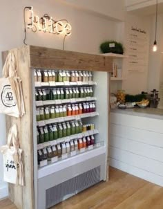 a display case in the middle of a kitchen filled with juices and smoothies