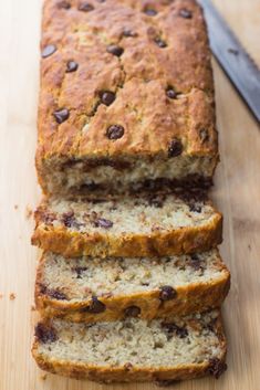 sliced loaf of banana bread sitting on top of a wooden cutting board