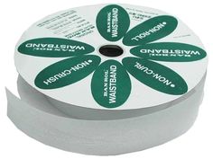 a roll of white tape with green labels on it