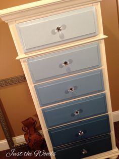 a blue and white chest of drawers in a room