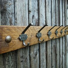 a wooden coat rack with five hooks on it