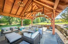 an outdoor covered patio with furniture and tables