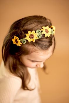 This charming headpiece features vibrant crocheted sunflowers, perfect for adding a touch of nature-inspired beauty to any outfit. 🌻 🌻 Each sunflower is carefully crocheted, making this headband a one-of-a-kind accessory.🌻 Comfortable Fit: Soft, stretchy material ensures a snug and cozy fit for kids of all ages.🌻 Versatile Use: Ideal for everyday wear, special occasions, or as a unique stocking stuffer.🌻 Great Gift Idea: Whether it's for a holiday, birthday, or just because, this sunflower headpiece is a delightful and thoughtful gift that will surely bring a smile to their face. Please note: Due to the handmade nature of our products, each headband may vary slightly, adding to its unique charm. 🌻 🪡 PRODUCT DETAILS:* Materials: Crochet* Size: ~ 5 inches diameter* Durable design, hig Crochet Sunflower Headband, Crocheted Sunflowers, Crochet Flower Crown, Sunflower Headpiece, Sunflower Headband, Unique Stocking Stuffers, Crochet Size, Crochet Sunflower, Eyeglass Chain