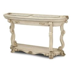 a white console table with two drawers and an open shelf on the bottom, in front of