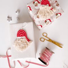 a pair of scissors sitting on top of a white box next to some christmas decorations