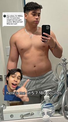 a shirtless man taking a selfie in front of a mirror with his cell phone