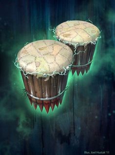 two cakes with icing on them sitting in front of a blue background and green light