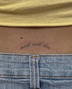 a woman with a tattoo on her stomach saying made with love