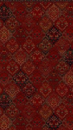 a red rug with many different colors and patterns on the carpet is shown in this image