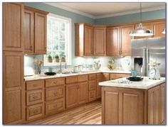 a kitchen filled with lots of wooden cabinets