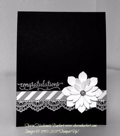 a black and white congratulations card with a flower on the front, along with an embellishment that says congratulations