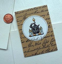 a penny sitting on top of a piece of paper next to an envelope with writing