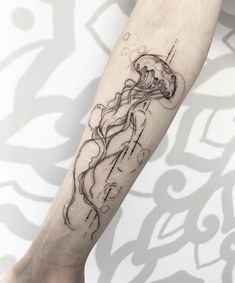 a woman's leg with a tattoo on it and a jellyfish in the water