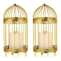 two candles are in a golden birdcage