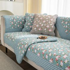 a couch covered in blue and pink flowers