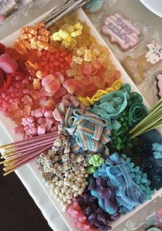 there are many different colored candies on the table