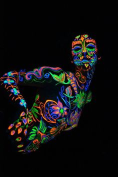 a body painted in neon colors with an artistic pattern on it's torso and legs