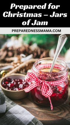 jars filled with jam on top of a wooden table next to spoons and pine cones